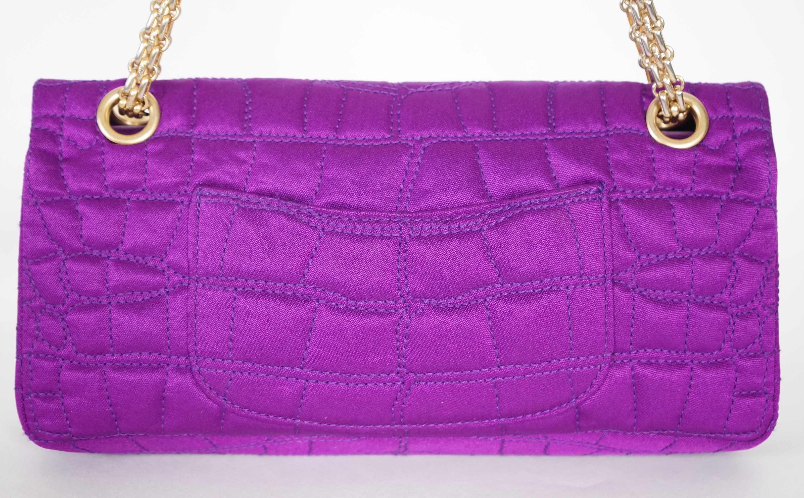 A Chanel medium-sized 2-55 bag in purple silk satin stitched with a quilted crocodile pattern, width 24cm, height 15cm, depth 6cm Single handle 112cm, Double handles 65cm